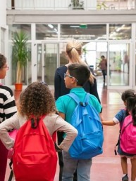 group-children-with-female-teacher-walking-school-corridor